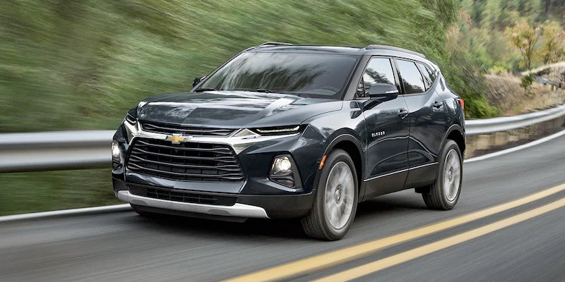Front side view of 2022 Chevy Blazer driving on a country highway