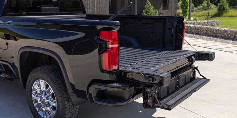 Rear side view of Chevrolet Silverado 2500 with bed and steps open