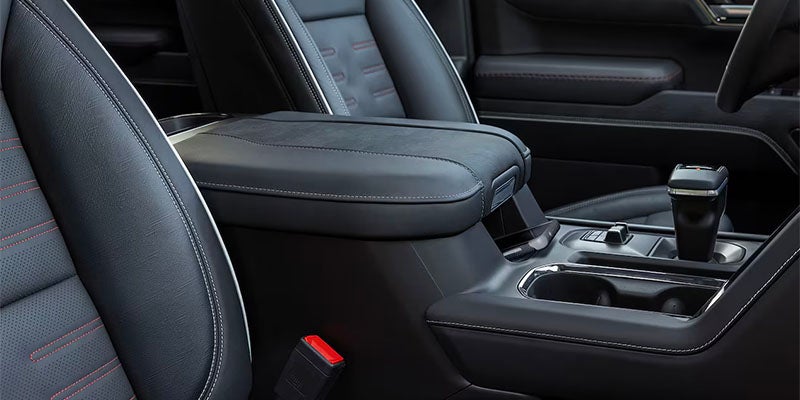 Close up view of center console, cup holder and gear shift