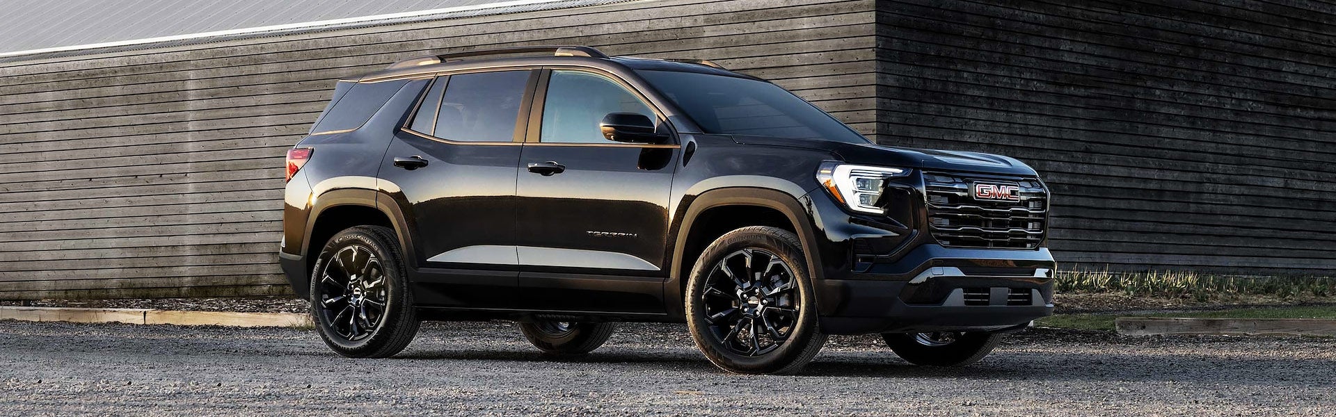 Side view of 2025 GMC Terrain parked on a gravel road